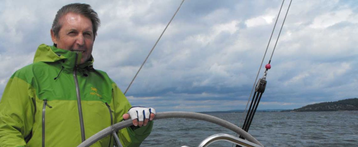 Image of Butch in his green jacket on board his boat in Georgian Bay