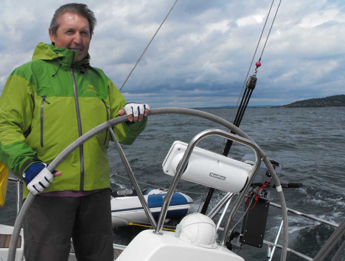 Image of Butch in his green jacket on board his boat in Georgian Bay