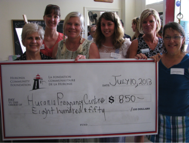 Six women standing behind a very large cheque made out the the Huroia Pregnancy Centre for $800